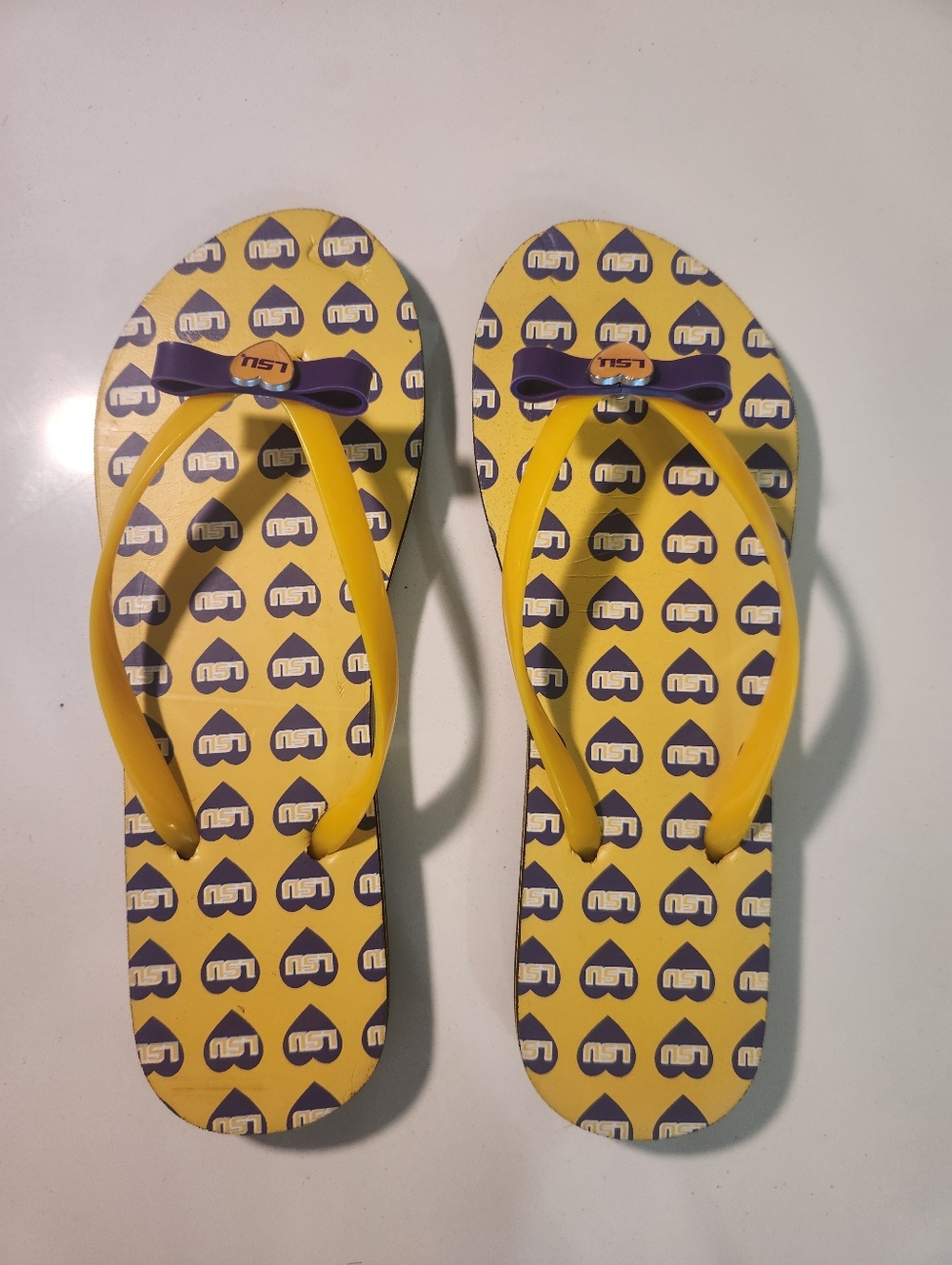 Women's LSU Yellow & Purple Logo Heart All Over Flip Flops with Bow Accent